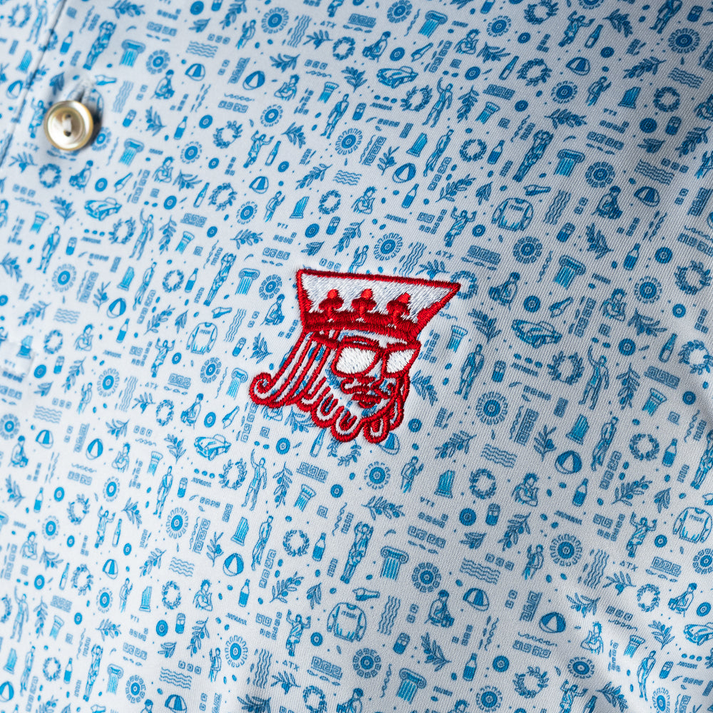 Peter Millar x SWAG light blue golf polo with mini icon print and embroidered red SWAG King logo on chest. 