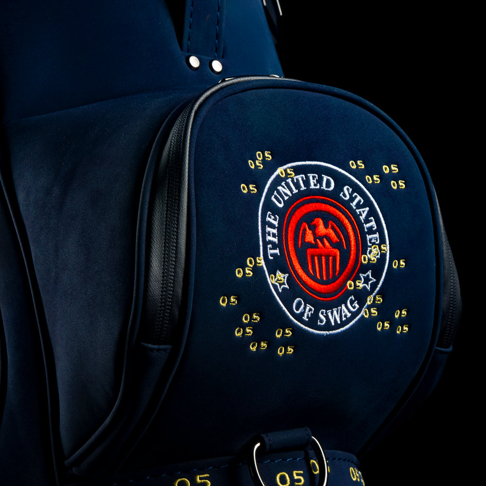 RWB Lincoln Den Caddy insulated cooler blue bag featuring embroidered $5 bill graphics and United States of SWAG emblem.