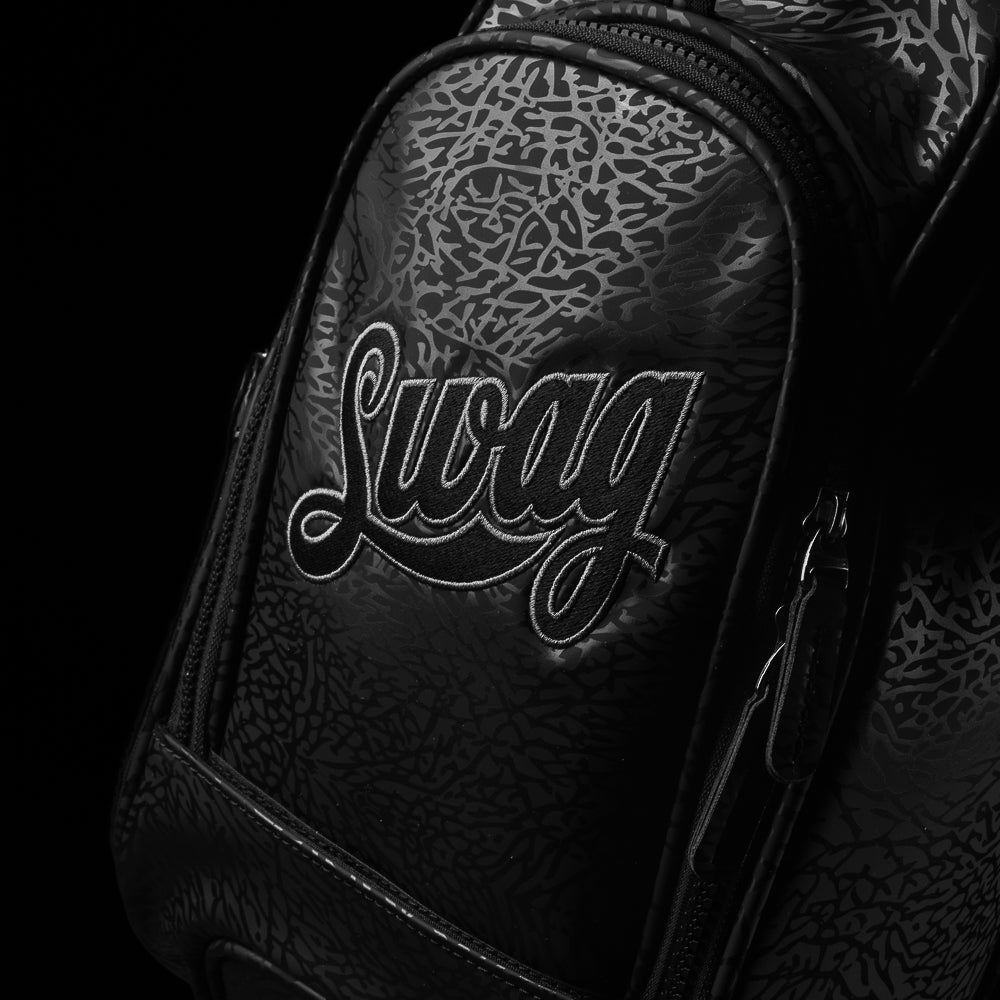 SWAG Golf all black golf stand bag with greatest hits designs on the side panels.