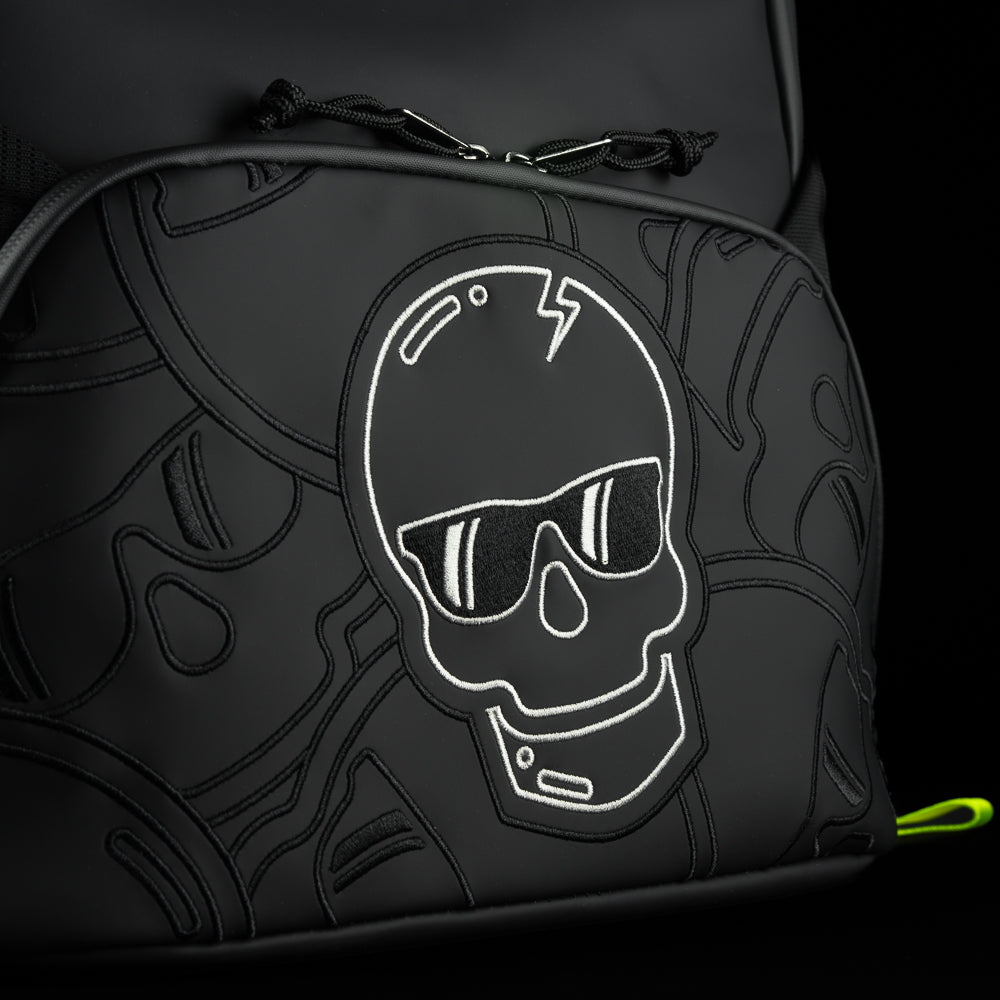 SWAG Golf black stacked skulls backpack with neon yellow straps.